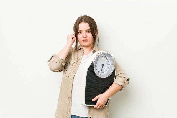 depositphotos_331860178-stock-photo-young-curvy-woman-holding-scale.jpg